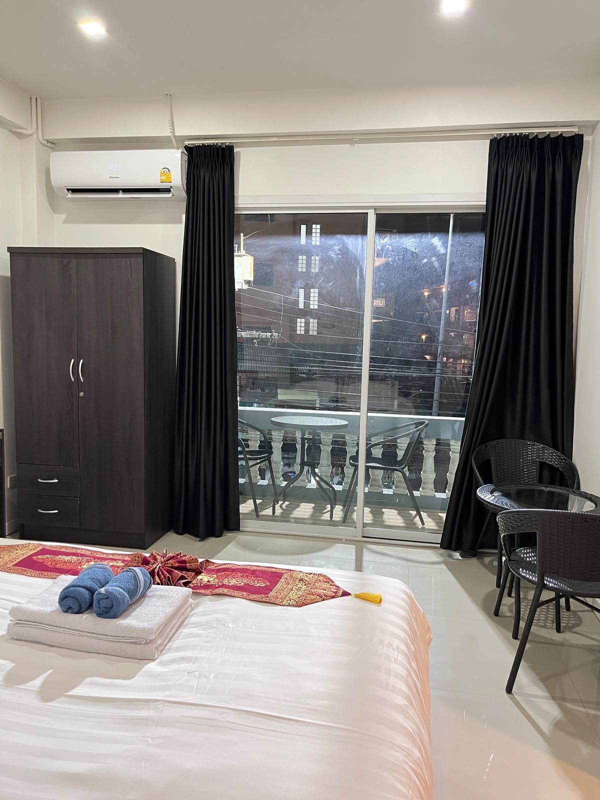 Room with balcony and black curtains