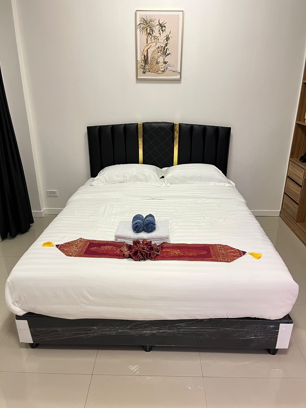 Room with black and gold headboard